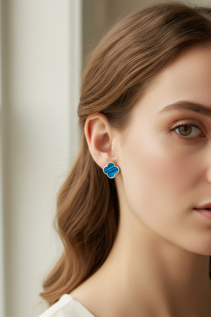 Lady wearing blue clover stud earrings