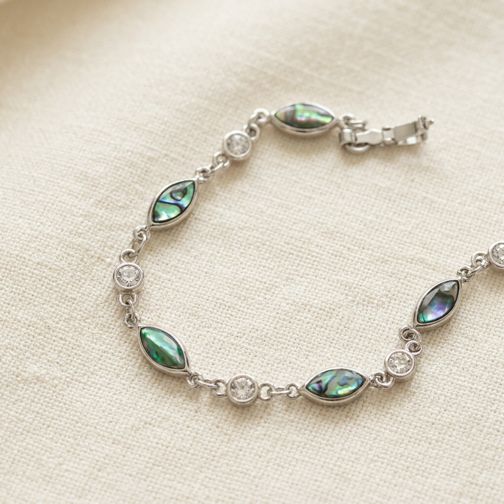 Paua shell bracelet on classic ivory linen