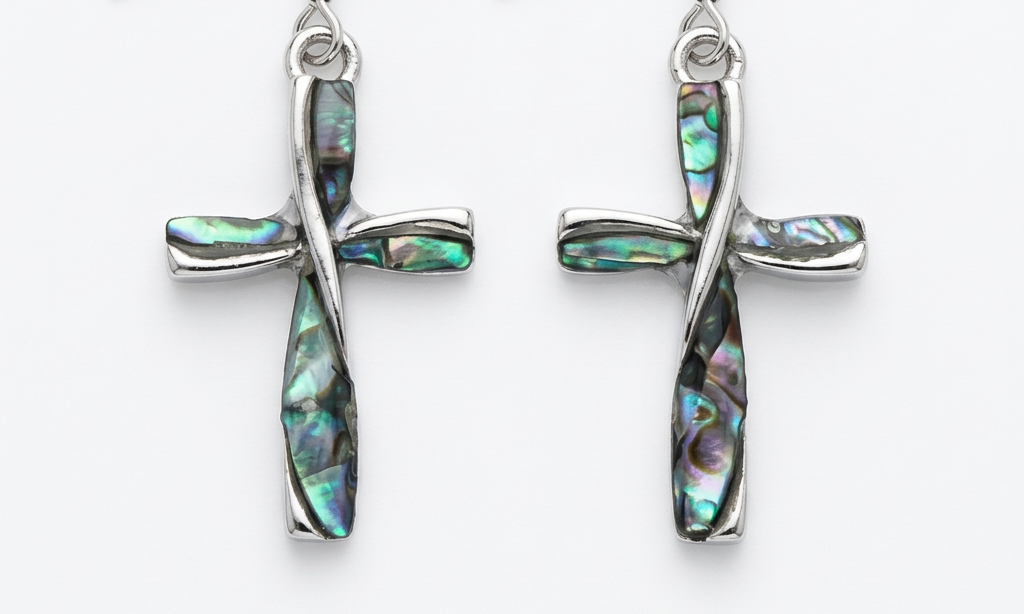 Paua shell cross earrings on a clean white background