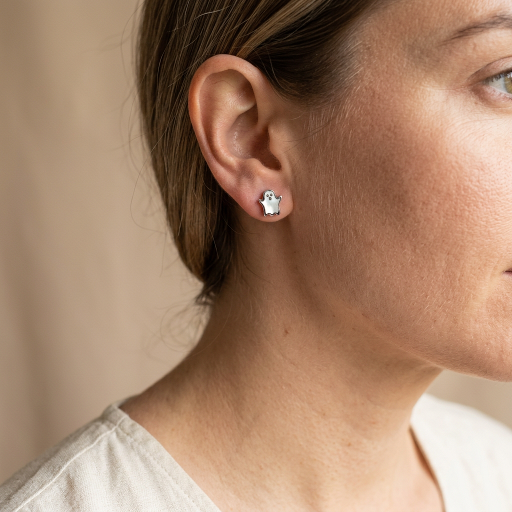 Woman wearing a small mother of pearl ghost stud earring